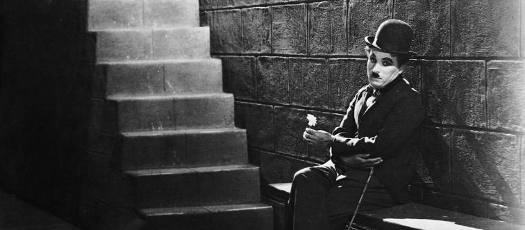 Which silent cinema pioneer became a global icon by wandering the screen as the bowler-hatted “tramp”?