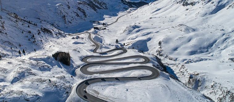 Which driving approach is most crucial when managing the hairpin turns of Europe's Alps?