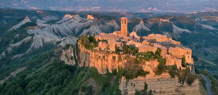 Which Italian hill town clings to its eroding peak in this photo?